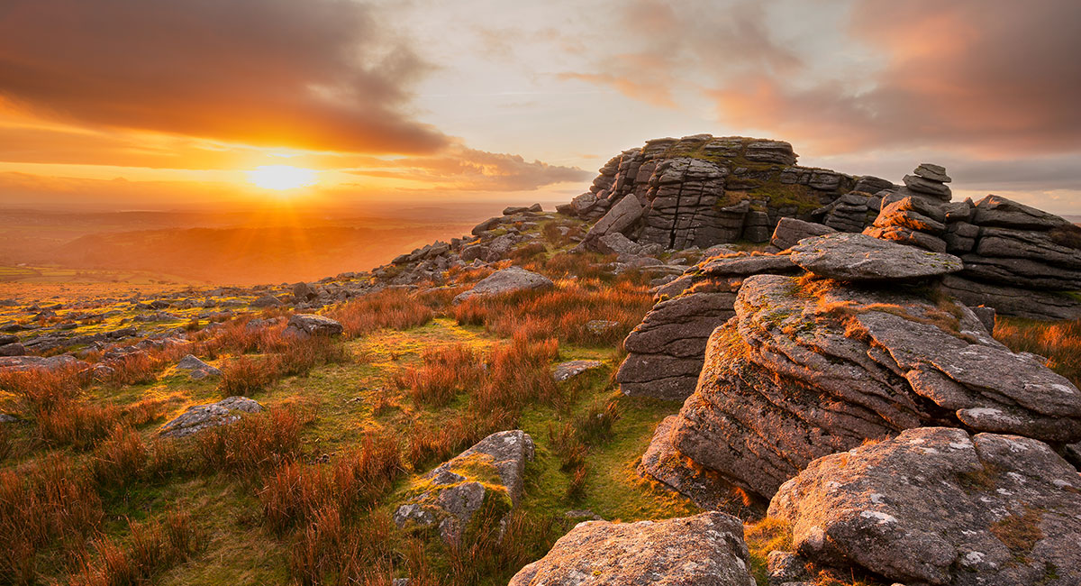 Golden light bathes the moors at sunset from Kings Tor, Dartmoor